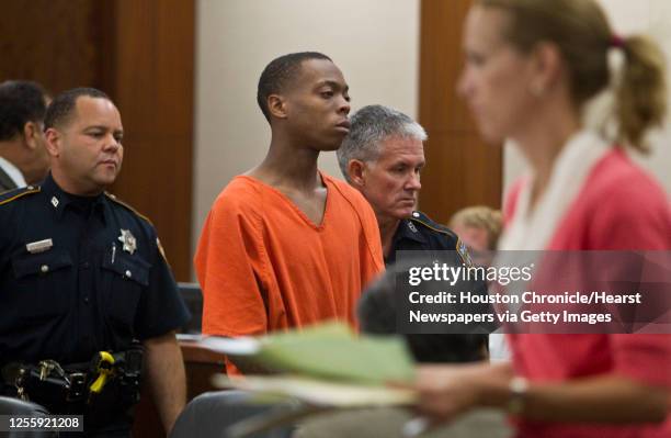 Curtis Odette Robinson is escorted after appearing in Judge Mark Kent Ellis' 351st State District Court by bailiffs Tuesday,Aug. 17 in Houston....