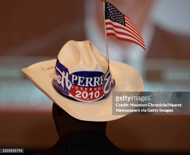Dr. Muyi Arowosafe wears a cowboy hat with stickers supporting Harris County Judge Ed Emmett and Governor Rick Perry during the Republican election...