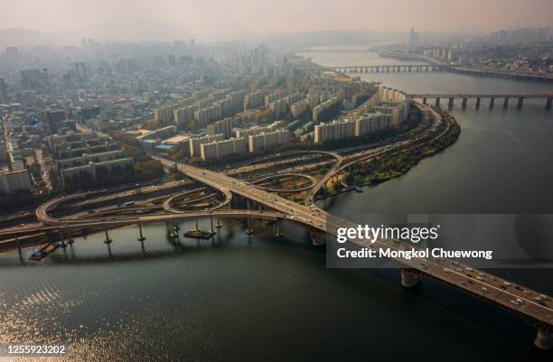 aerial view of highway road junctions. the intersecting freeway road overpass of seoul downtown city skyline with vehicle on expressway and bridge cross over han river in seoul city, south korea. - hanfloden bildbanksfoton och bilder