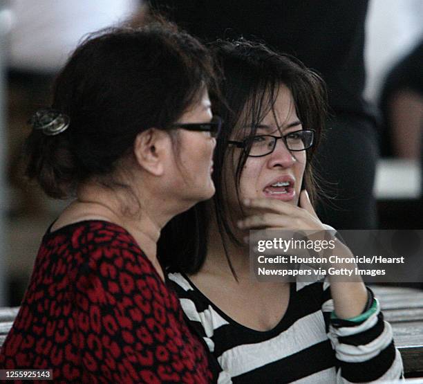 Xuyen Phan right, who was one of several hostages during a bank robbery at the Chase Bank sits with her mother Sue Nguyen left, after being released.