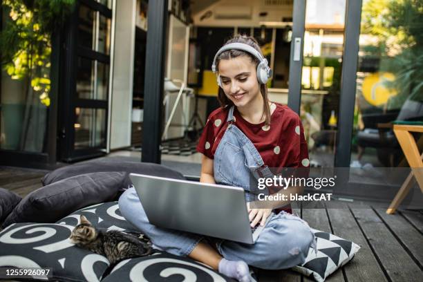 enjoying a day off at home - girl with earphones stock pictures, royalty-free photos & images