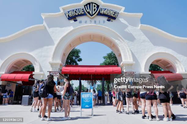 People are seen entering the Warner Theme Park and a sign indicates hygienic measures on July 13, 2020 in Madrid, Spain. Together with the rest of...