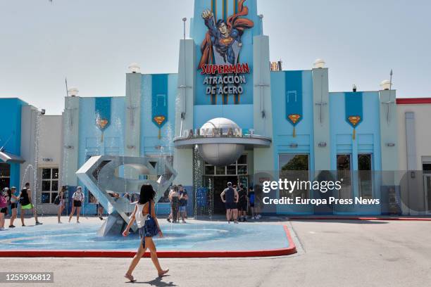 Woman with a mask passes by an attraction at the Warner Theme Park on July 13, 2020 in Madrid, Spain. Together with the rest of Reunited Parks in the...