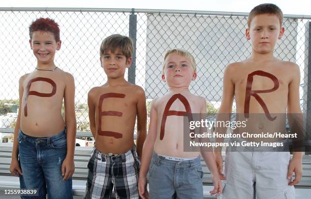 Pearland fans, from left, Charlie Clark,8., Mitchell Krum, 8., Matthew Dennis 8, and AJ Abbott .show off the word "Pear" on their chests and "Land"...