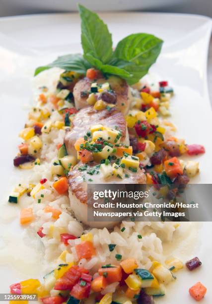 Seared scallops, risotto primavera, spring vegetables, pancetta,bianco at Trevisio restaurant in the Texas Medical Center Wednesday, Aug. 3 in...