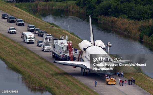 The space shuttle Atlantis is towed from the landing strip to the OPF ( Orbiter Processing Facility after completing the final mission of the space...