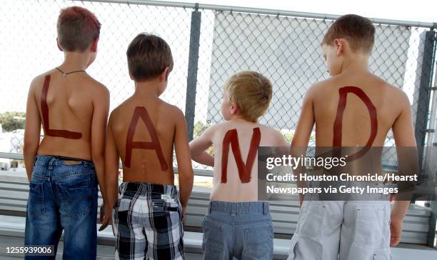 Charlie Clark 8yrs., Mitchell Krum 7yrs., Matthew Dennis 7yrs. And AJ Abbott 8yrs. Show off "Land" on their backs and "Pear" on their chest before...