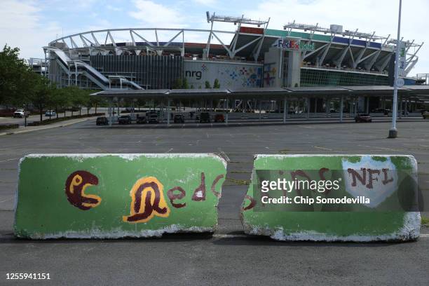 Hand painted concrete barriers stand in the parking lot of FedEx Field, home of the NFL's Washington Redskins team July 13, 2020 in Landover,...