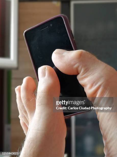 man using smart phone with his feet - toe stock-fotos und bilder