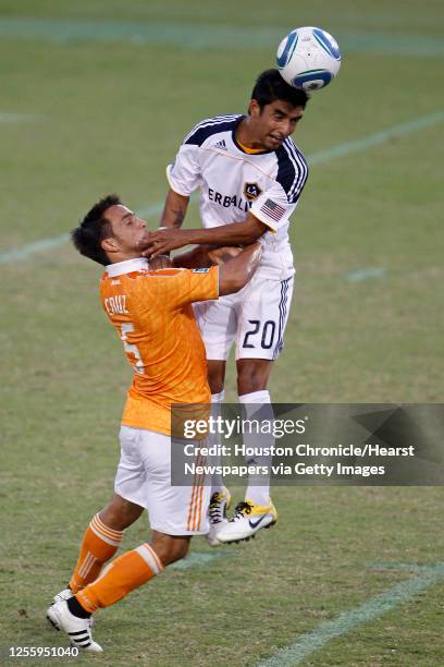 The Houston Dynamo's Danny Cruz collides with A.J. DeLaGarza of the LA Galaxy during the first period of MLS game action at Robertson Stadium Sunday,...