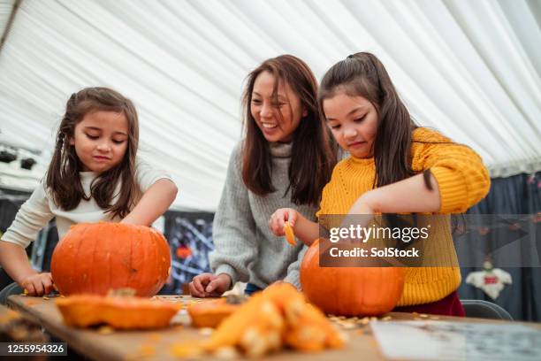 carving pumpkins with mummy - pumpkin decorating stock pictures, royalty-free photos & images