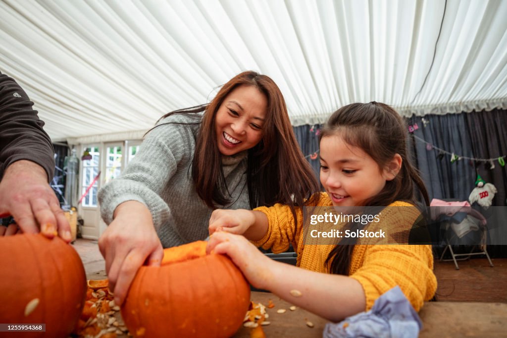 Mother and Daughter Carving Pumpkins