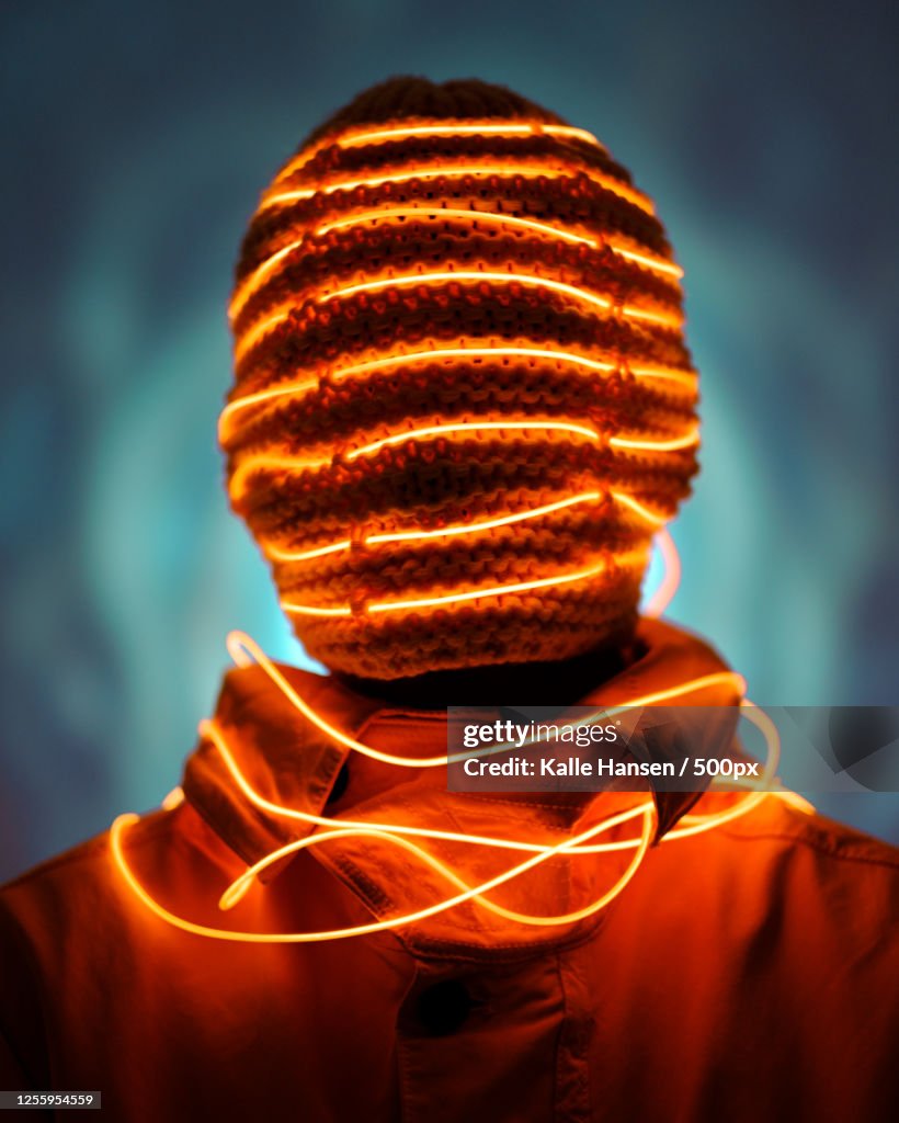 Studio shot of person wearing illuminated mask