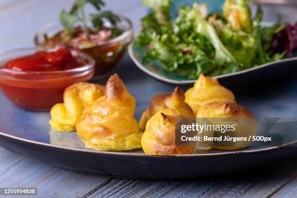 duchess potatoes with sauce and lettuce - duchess potatoes stock pictures, royalty-free photos & images