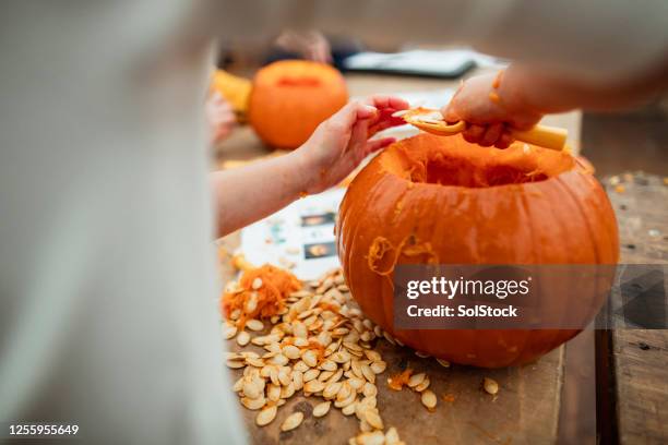 getting messy with pumpkins - carving stock pictures, royalty-free photos & images