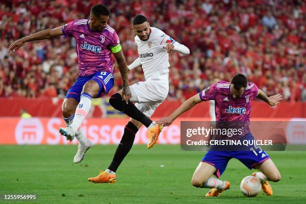 Juventus' Italian defender Federico Gatti controls the ball next to Juventus' Brazilian defender Danilo and Sevilla's Moroccan forward Youssef...