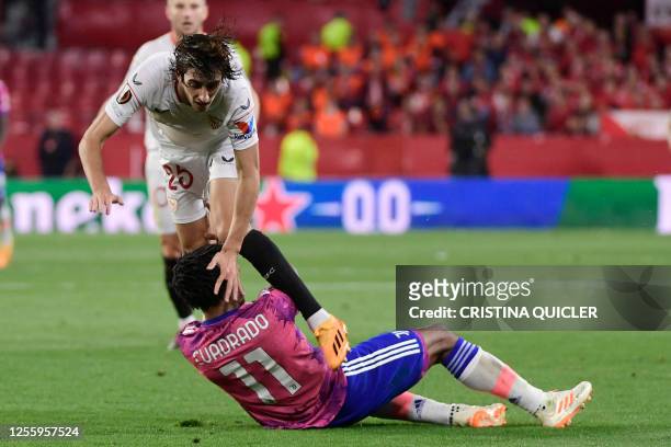 Sevilla's Spanish forward Bryan Gil collides with Juventus' Colombian defender Juan Cuadrado during the UEFA Europa League semi-final second leg...