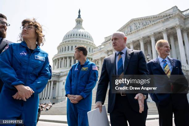 Astronauts Christina Hammock Koch and Reid Wiseman join Sen. Mark Kelly and NASA Administrator Bill Nelson as they arrive for a news conference about...