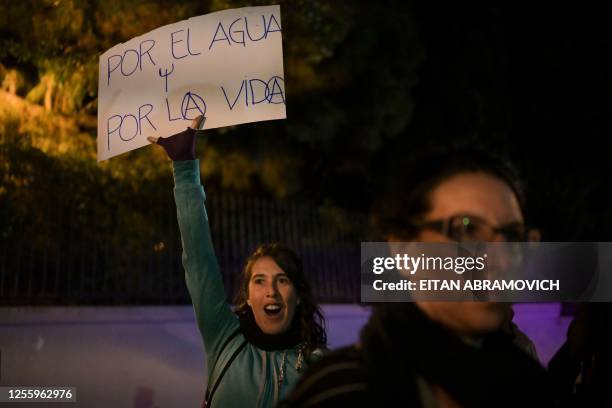 Demonstrator displays a placard reading "For Water and For Life" during a protest against the high levels of chloride and sodium in the water...