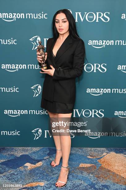 Charli XCX, winner of the Visionary Award with Amazon Music, poses in the winners room at The Ivors 2023 at The Grosvenor House Hotel on May 18, 2023...