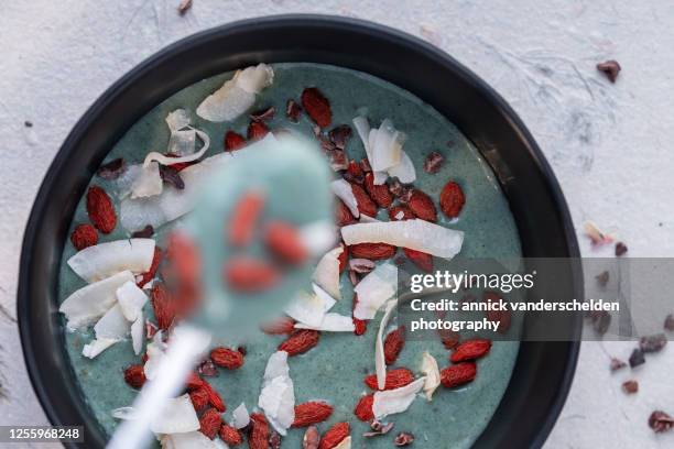 spirulina smoothie with toppings - nagerecht-garnering stockfoto's en -beelden