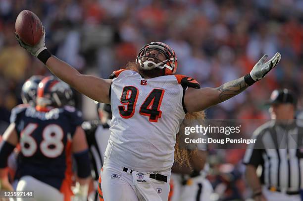 Domata Peko of the Cincinnati Bengals celebrates after recovering a fumble by quarterback Kyle Orton of the Denver Broncos at Invesco Field at Mile...