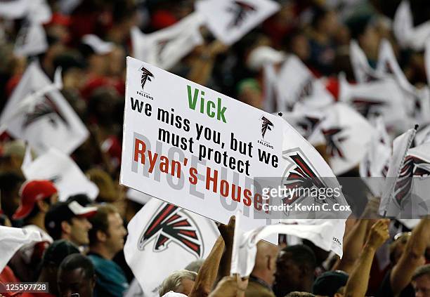 Fans of the Atlanta Falcons hold a sign about Michael Vick of the Philadelphia Eagles at Georgia Dome on September 18, 2011 in Atlanta, Georgia.