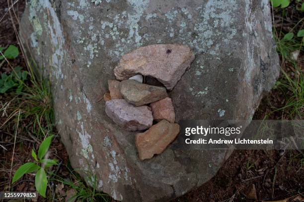 Stones placed on a rock mark the location of graves of Thomas Jefferson's slaves at his historical preserved plantation on July 8 outside of...