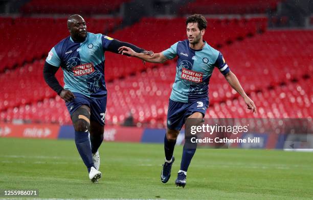 Joe Jacobson of Wycombe Wanderers celebrates with Adebayo Akinfenwa of Wycombe Wanderers after he scores from the penalty spot during the Sky Bet...