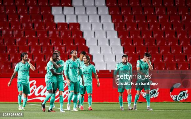 Ferland Mendy of Real Madrid is congratulated after scoring the opening goal during the Liga match between Granada CF and Real Madrid CF at on July...