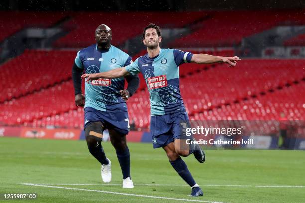 Joe Jacobson of Wycombe Wanderers celebrates with Adebayo Akinfenwa of Wycombe Wanderers after he scores from the penalty spot during the Sky Bet...