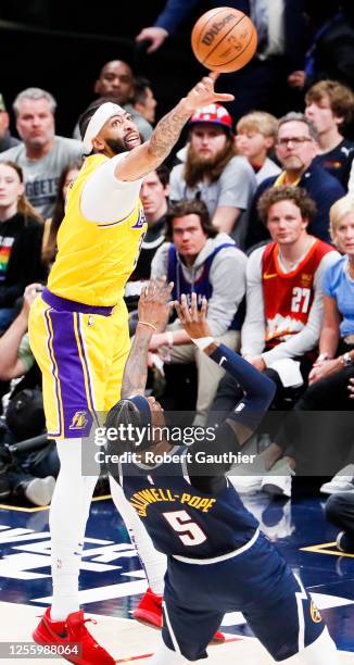 Los Angeles Lakers forward Anthony Davis, left, blocks a shot by Denver Nuggets guard Kentavious Caldwell-Pope during the first half of game two in...