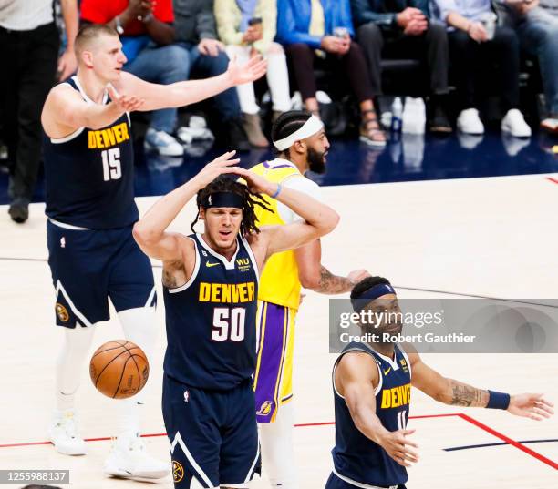 Denver Nuggets forward Aaron Gordon, center, and forward Bruce Brown react during the first half of game two in the NBA Playoffs Western Conference...