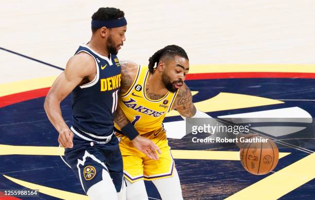 Los Angeles Lakers guard D'Angelo Russell, right, handles the ball while Denver Nuggets forward Bruce Brown defends during the first half of game two...