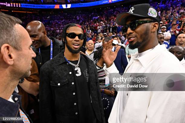 Damar Hamlin speaks with Donovan Mitchell of the Cleveland Cavaliers during round two game six of the 2023 NBA Playoffs between the Boston Celtics...