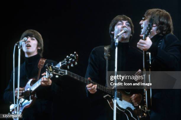 George Harrison , Paul McCartney and John Lennon of The Beatles perform at Empire Pool in Wembley at the New Musical Express Annual Poll Winner's...