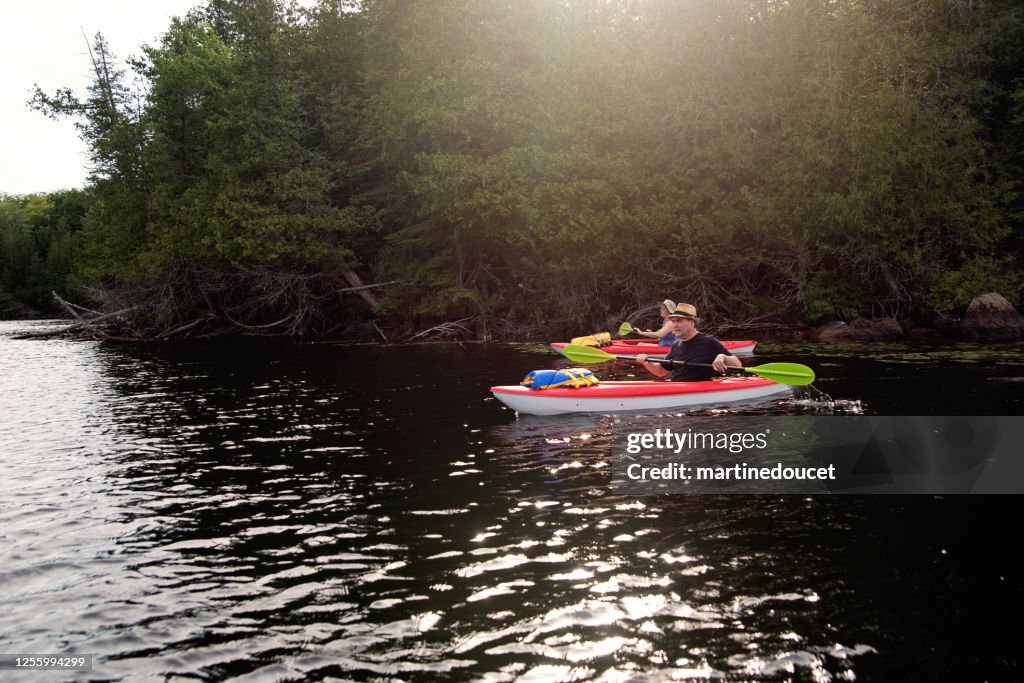 50 + man and woman kayaking on a lake.