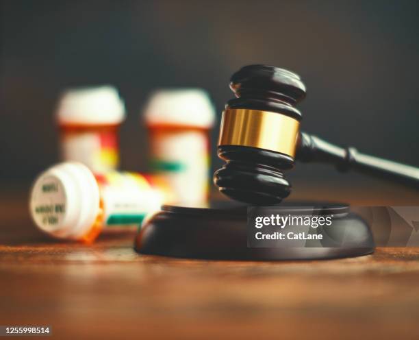 judge's gavel with medications. medical malpractice - crime law and justice stock pictures, royalty-free photos & images