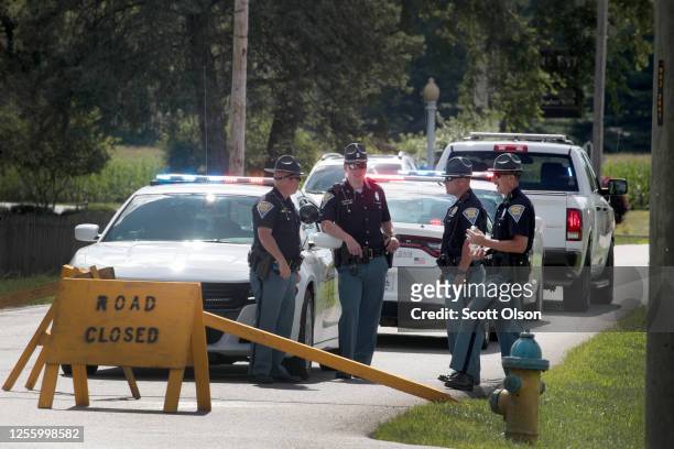 Police man a road block to keep people away from the Federal Correctional Complex where Daniel Lewis Lee was scheduled to be executed on July 13,...
