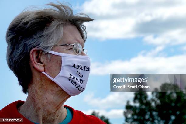 Demonstrator expresses opposition to the death penalty during a protest near the Federal Correctional Complex where Daniel Lewis Lee is scheduled to...