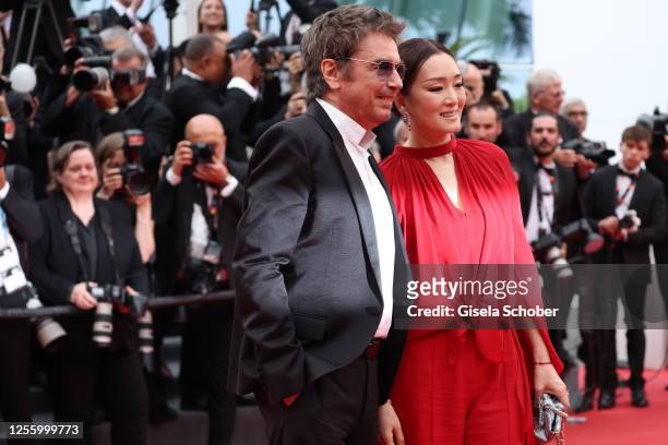 Jean-Michel Jarre and Gong Li attend the "Indiana Jones And The Dial Of Destiny" red carpet during the 76th annual Cannes film festival at Palais des...