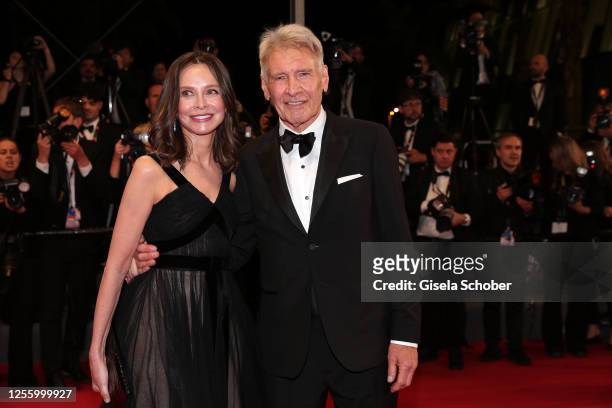 Calista Flockhart and Harrison Ford depart the "Indiana Jones And The Dial Of Destiny" red carpet during the 76th annual Cannes film festival at...