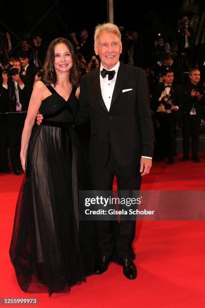 Calista Flockhart and Harrison Ford depart the "Indiana Jones And The Dial Of Destiny" red carpet during the 76th annual Cannes film festival at...