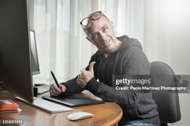 portrait of bald man working at his computer at home - hairless mouse stock pictures, royalty-free photos & images