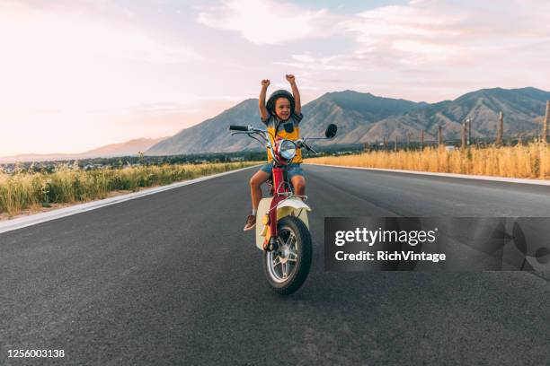 young boy on retro scooter - riding vespa stock pictures, royalty-free photos & images