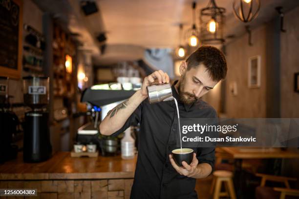 barista is making coffee with milk - barista coffee milk stock pictures, royalty-free photos & images