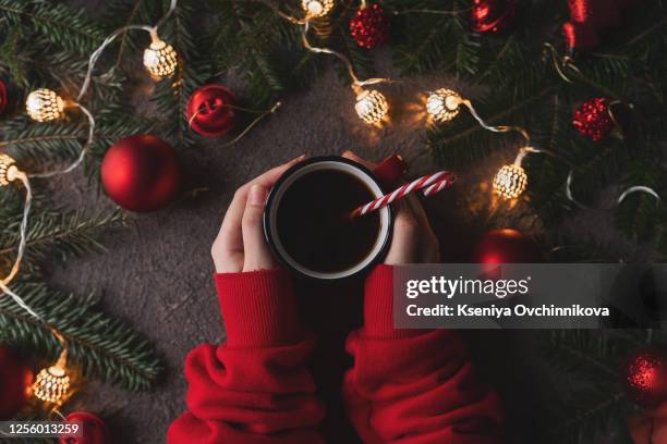 opening christmas present. woman's hands holding decorated gift box on rustic wooden table. ideal christmas morning. overhead, flat lay, top view - chocolate top view stock-fotos und bilder