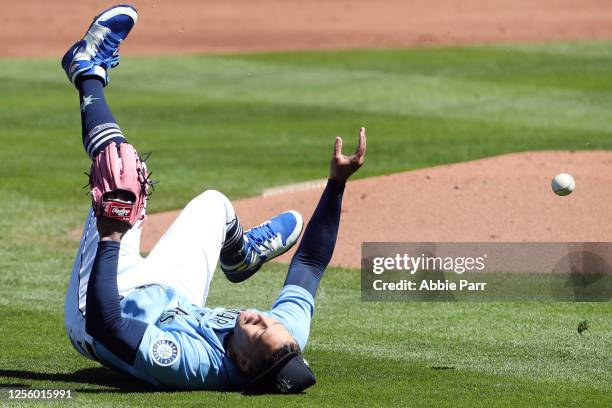 Taijuan Walker of the Seattle Mariners falls down after a missed attempt to make an out at first base in the first inning during an intrasquad game...