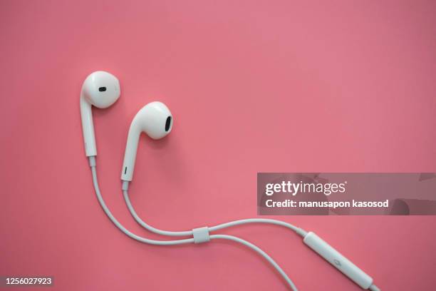 in-ear headphones - in ear headphones stock pictures, royalty-free photos & images