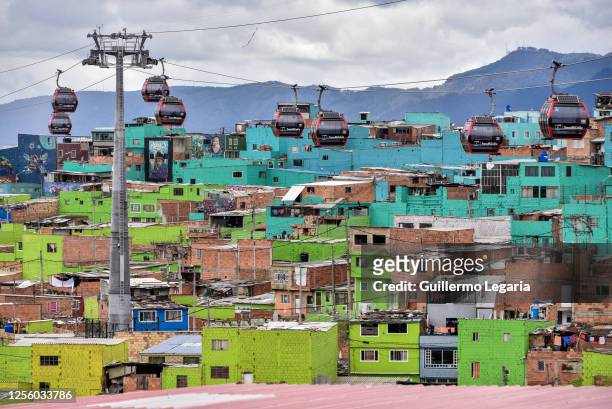 Cable cars of Bogota's "TransMiCable" public transport system are seen over the neighbourhood of Ciudad Bolivar on July 13, 2020 in Bogota, Colombia....